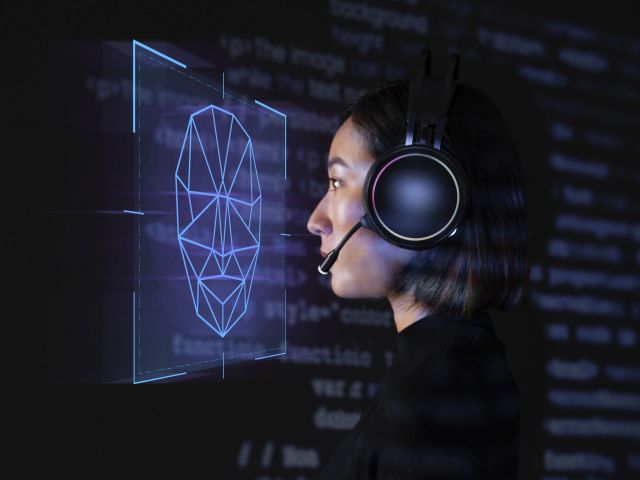 Female programmer scanning her face with biometric security tech